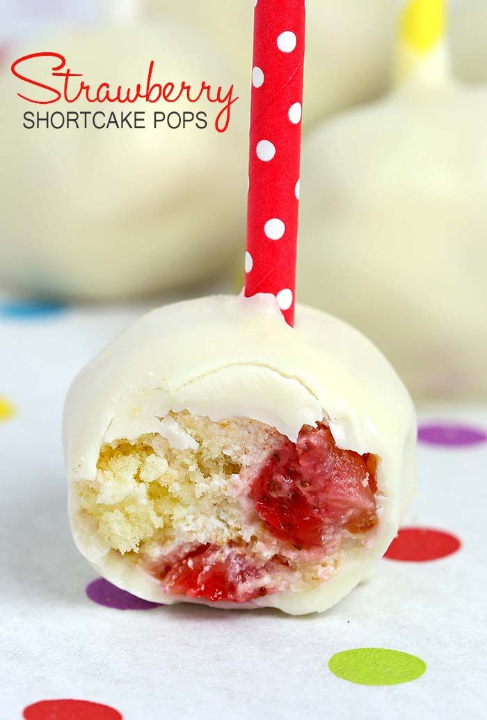 a strawberry shortcake pops on a polka dot tablecloth with a red and white straw