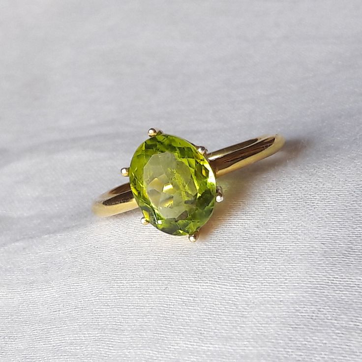 The Buyer Must Be Reads All Details About The Product . Material  14k Yellow Gold  . Gemstone  Natural Peridot  . Gemstone Colour .... Green . Gemstone Size  6x8 mm . Gemstone Shape  Oval . Birthstone  August Birthstone Peridot Band Ring, Classic Oval Green Sapphire Ring, Green Oval Sapphire Ring With Center Stone, Classic Green Oval Sapphire Ring, Elegant Green Oval Topaz Ring, Classic Green Sapphire Oval Ring, Green Oval Cabochon Emerald Ring For Wedding, Green Emerald Oval Cabochon Ring For Wedding, Classic Peridot Gemstone Diamond Ring