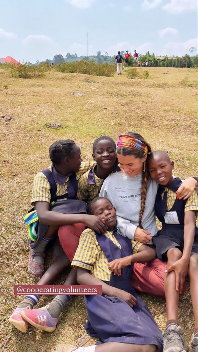 a group of children sitting on the ground together