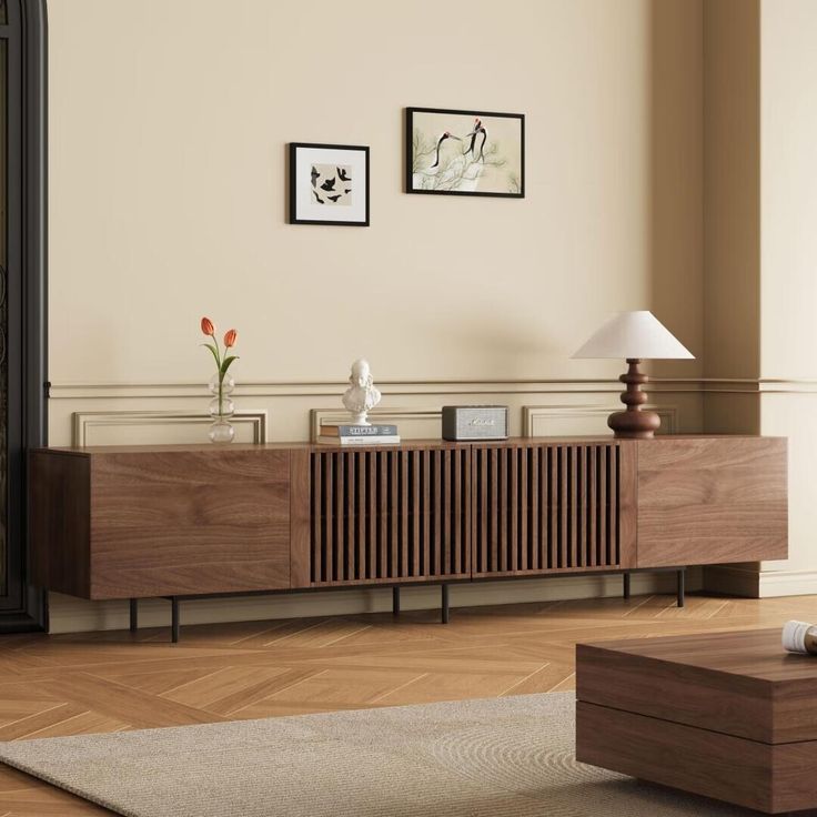 a living room scene with focus on the sideboard and table in the foreground