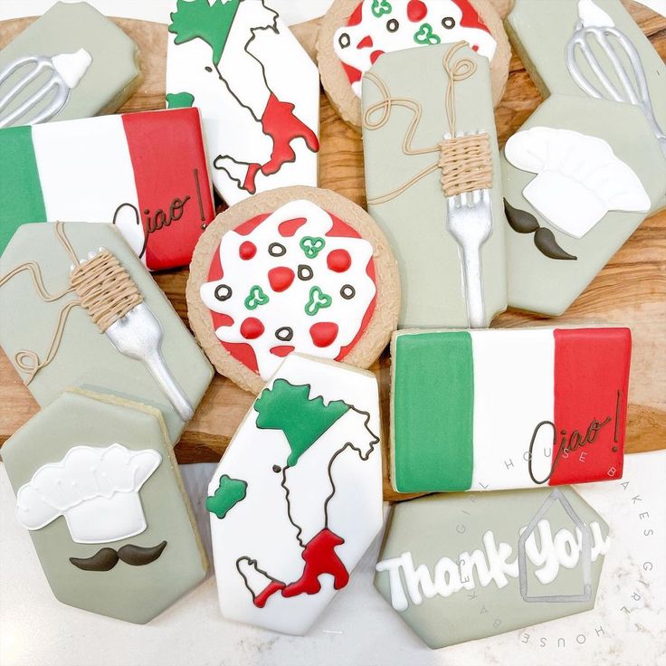 decorated cookies are arranged in the shape of italy