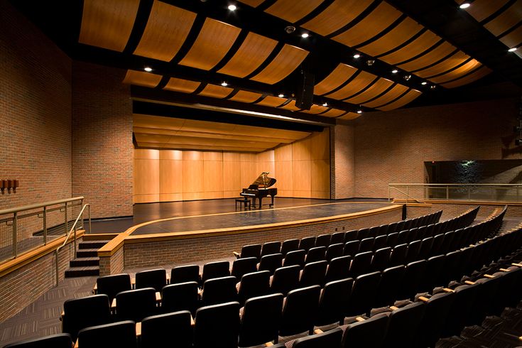 an empty auditorium with a grand piano on the stage