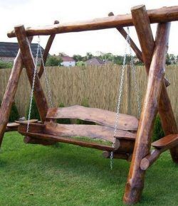 a wooden swing with chains attached to it