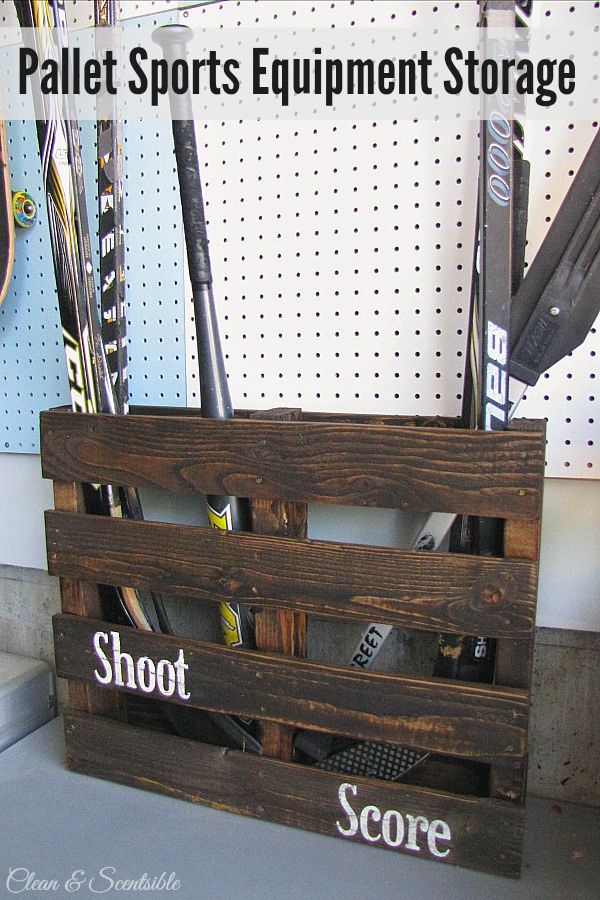 a pallet sports equipment storage box with baseball bats in it and the words shoot score written on it