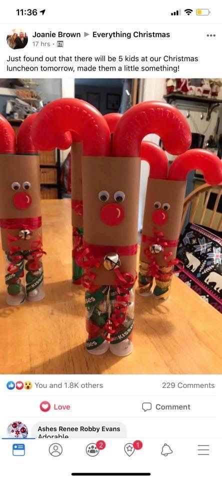 three toilet paper roll christmas decorations sitting on top of a wooden table next to each other