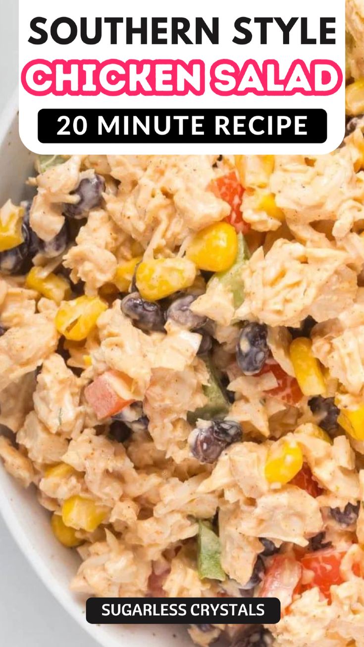 the southern style chicken salad is in a white bowl with black olives and corn