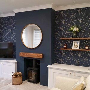 a living room with blue walls and white furniture in front of a tv mounted on a wall