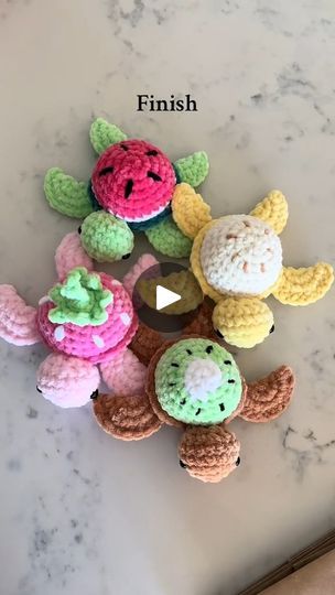 several crocheted toys are sitting on a counter top, with the words finish written above them