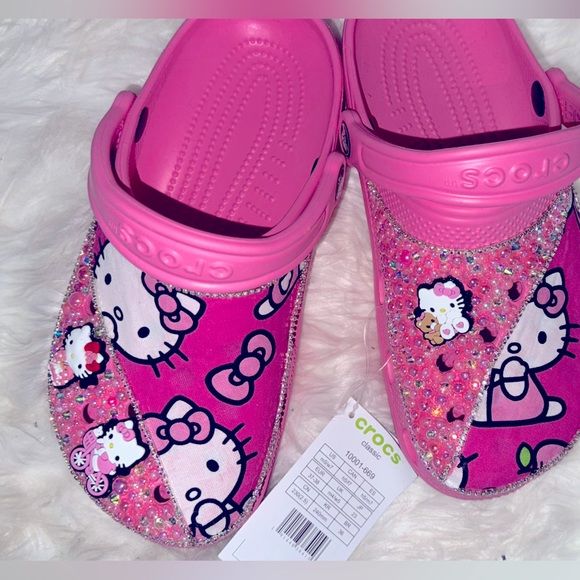 Shop sunshinehappy13's closet or find the perfect look from millions of stylists. Fast shipping and buyer protection. Turn heads with these customized hello kitty crocs Hello Kitty Curling Iron, Hello Kitty Bling Crocs, Pink Hello Kitty Crocs, Cheer Crocs, Decorated Crocs, Cute Crocs Shoes, Hello Kitty Crocs, Crocs With Charms, Shoes Customized