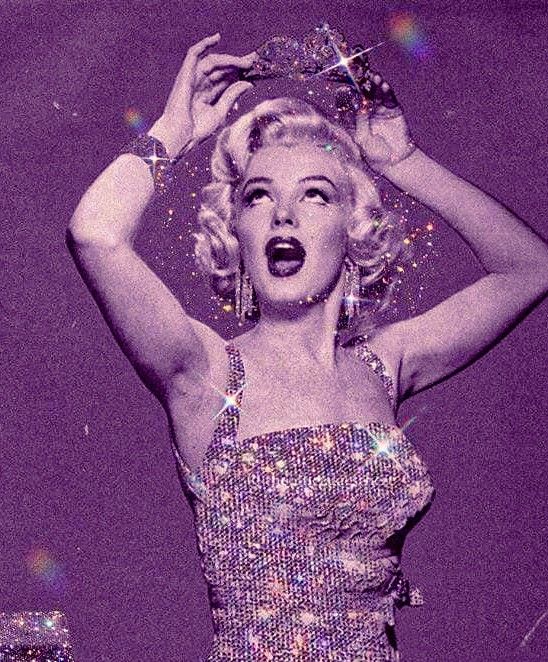 a woman in a sequined dress with her hands on her head and mouth open