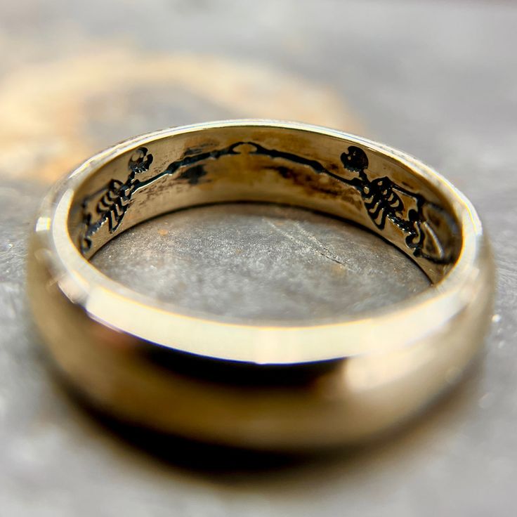 a gold ring with writing on it