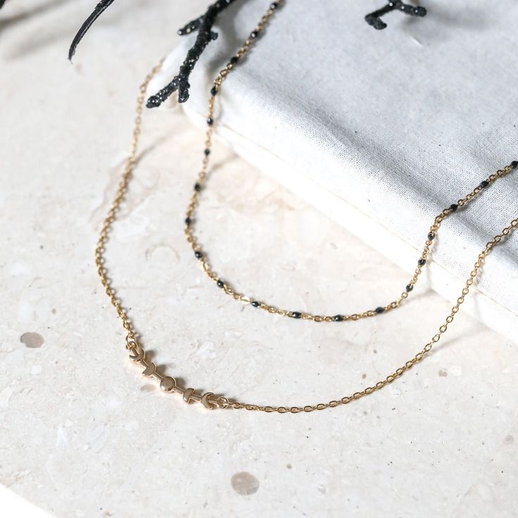 A gold moon phase bar charm set between gold stainless steel chain and paired with a shorter black enamel chain. This necklace does all the layering for you! Pool Dip, Fairy Candles, Cottage Witch, Silver Jewelry Accessories, Double Necklace, Witch Jewelry, Back Jewelry, Gold Moon, Practical Magic