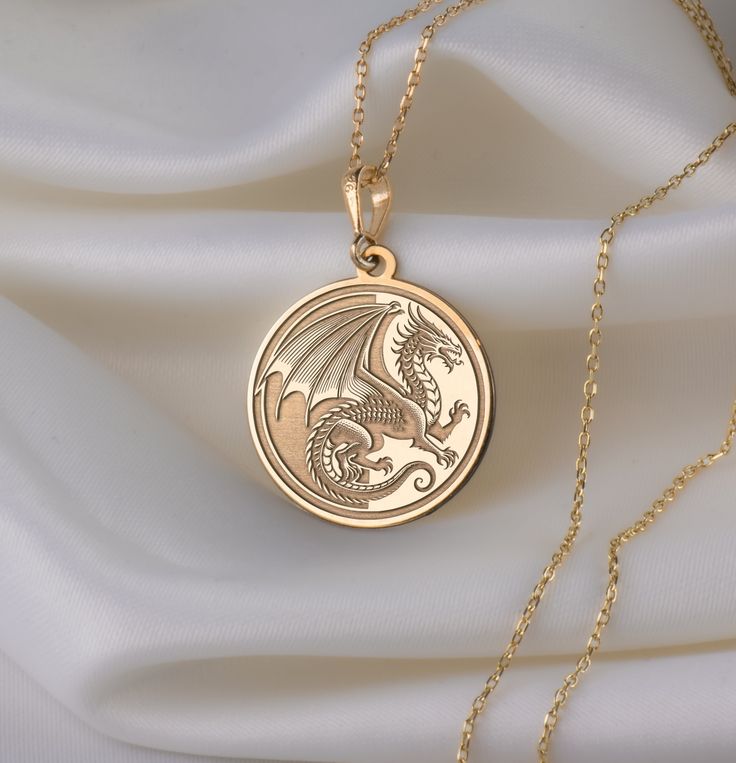 🐉 Step into the enchanting realm of Chinese New Year with our mesmerizing dragon necklace! 🎉 Crafted with meticulous attention to detail, this exquisite piece is a vibrant celebration of tradition, strength, and auspicious beginnings. Imagine the majestic dragon, intricately designed with shimmering scales ✨ and fierce claws, symbolizing power and resilience. With each wear, you'll embody the spirit of this mythical creature, carrying with you the energy of the Lunar New Year. 🌟 ★ Material Va Sterling Silver Necklace With Dragon Design, Fantasy Brass Jewelry For Gifts, Gold Dragon Design Jewelry, Dragon Design Jewelry For Gift, Dragon Design Amulet Necklace, Round Dragon Design Jewelry For Gifts, Gold Jewelry With Dragon Design, Dragon Design Jewelry Gift, Round Dragon Design Necklace For Gift