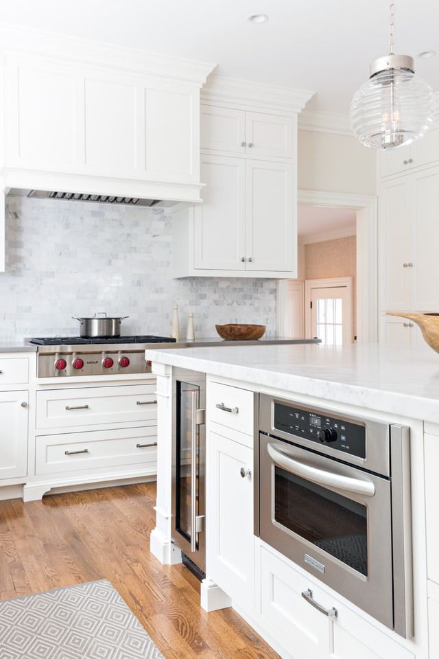 a large kitchen with white cabinets and stainless steel stove top oven, dishwasher and microwave