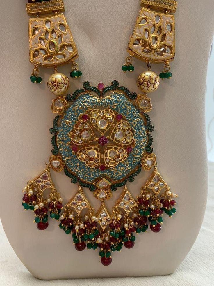 Lovely kundan and meenakari necklace. . Comes with equally gorgeous matching earrings. Has vibrant red, green, and blue colors. (Last picture shows the backside of the necklace) Luxury Meenakari Necklaces For Designer Wear, Luxury Meenakari Necklace For Festivals, Luxury 22k Gold Meenakari Necklace, Luxury Multicolor Meenakari Chandbalis, Luxury Meenakari Designer Necklaces, Luxury Brass Jewelry With Meenakari, Luxury Designer Meenakari Jewelry, Luxury Yellow Gold Meenakari Jewelry, Festival Meenakari Temple Necklace Pendant