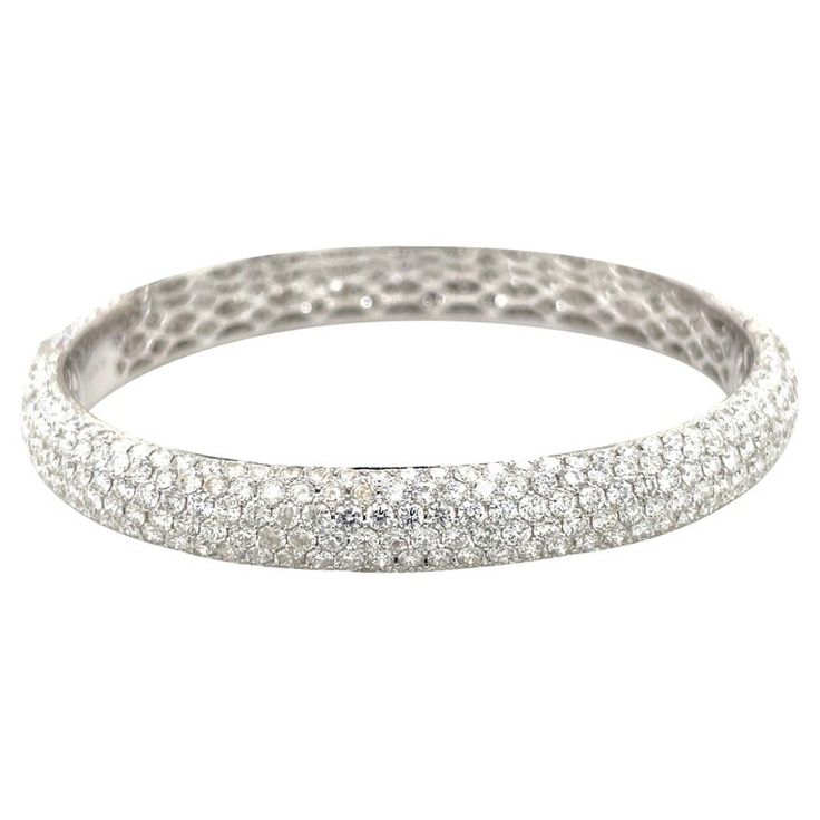 Magnificently set 18 karat white gold pave' diamond bangle bracelet. The oval shaped bracelet has a total of 621 round brilliant diamonds with a total weight of 15.68 carats. The beauty of this bracelet is the oval shape, which sits so comfortably on the wrist without spinning around. The bracelet has an invisible closure for a seamless design. Stamped 18k 750 Also available in yellow and rose gold, and black diamonds. Diamond Bangle Bracelet, Flawless Diamond, Modern Bracelets, Diamond Bangles Bracelet, Expensive Jewelry, Black Diamonds, Diamond Bangle, Diamond Bracelets, Brilliant Diamond