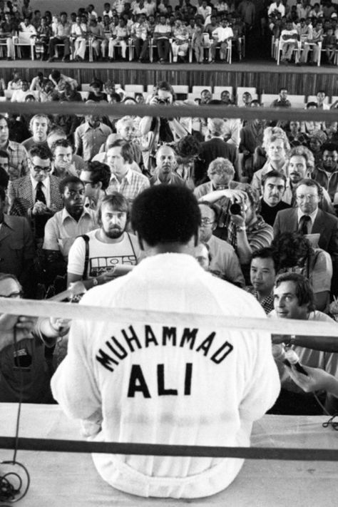 a baseball player standing in front of a crowd