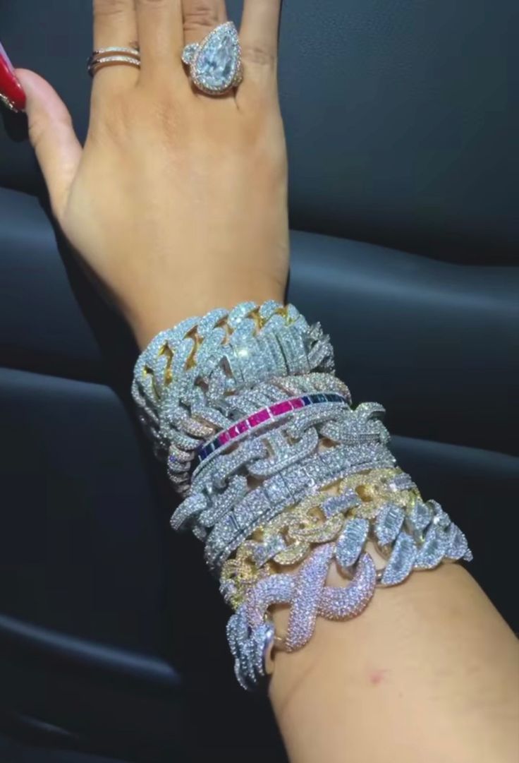 a woman's hand with several bracelets on it