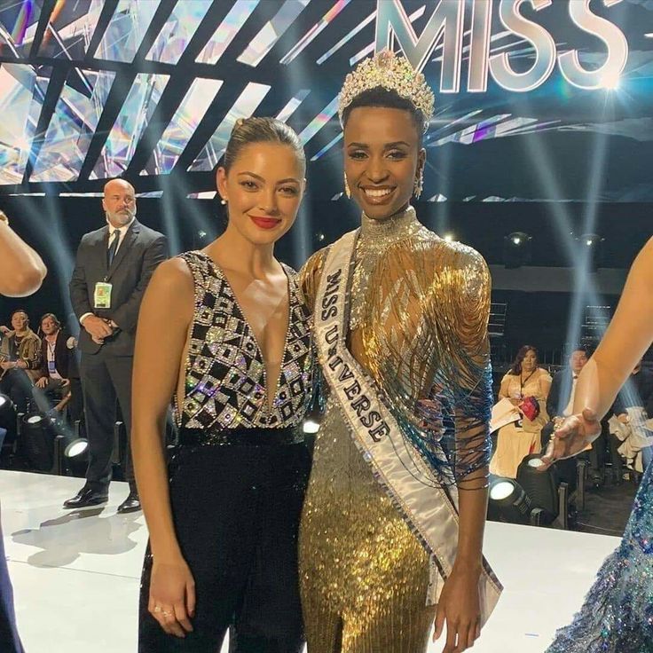 two women standing next to each other at a competition