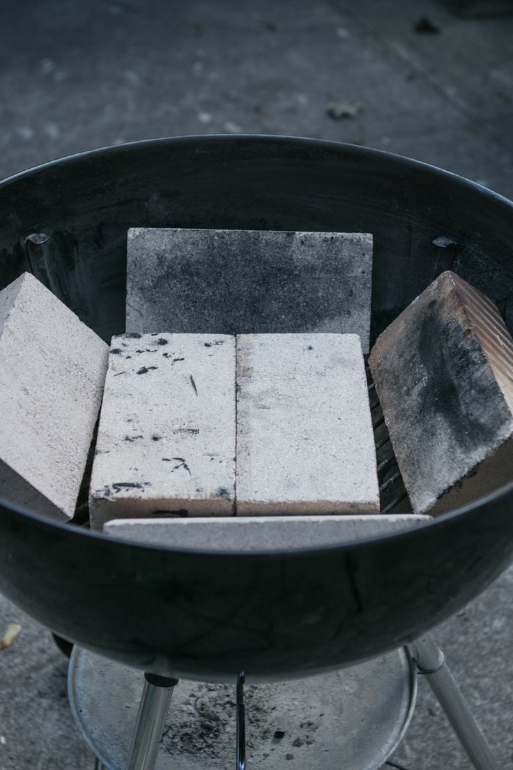 several blocks of concrete sitting on top of a grill