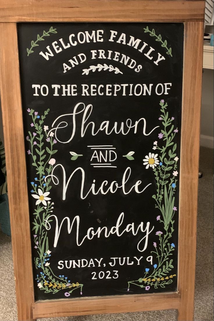 a chalkboard sign that says welcome family and friends to the reception of shawn and nicole monday