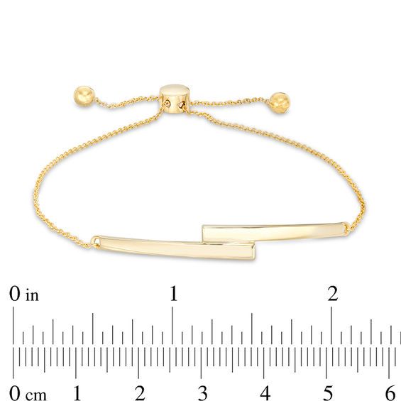 So chic and modern, this bar bolo bracelet complements any attire. Crafted in 10K gold, this on-trend look showcases two tapered bars bypassing at the center. Polished to a bright shine, this cable chain bracelet adjusts up to 9.5 inches in length and secures with a bolo clasp and ball ends. Sleek Adjustable Jewelry With Polished Finish, Adjustable Minimalist Gold Bracelet With Polished Finish, Sleek Adjustable Gold Jewelry, Modern Yellow Gold Adjustable Jewelry, Modern Adjustable 14k Gold Bracelet, Adjustable Rectangular Gold Bracelet, Modern Gold Jewelry With Sliding Knot, Adjustable Rectangular Gold Bracelet For Formal Occasions, Bolo Bracelet