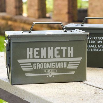 two army green coolers sitting on top of a cement bench next to each other