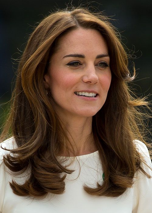 a woman with long brown hair wearing a white dress