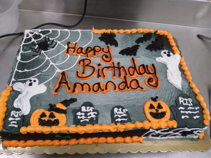 a birthday cake decorated with halloween decorations