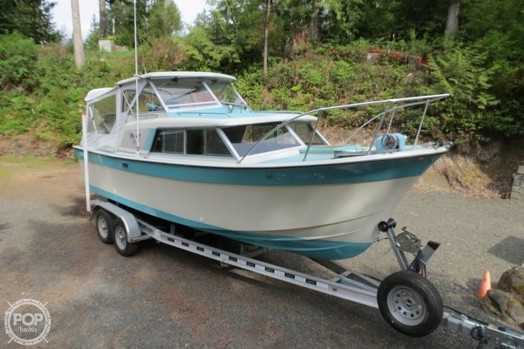 a white and blue boat sitting on top of a trailer