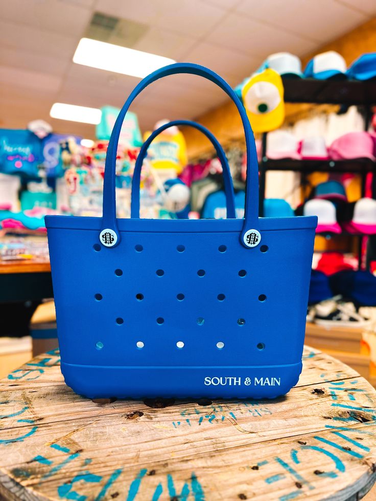 Indulge in some fierce fashion with our Royal Blue Tote Bag! Stay cute and trendy with this must-have tote bag. This versatile and cute bag is perfect for all your adventures, from the beach or the pool to the ball field or game day. The large size (19in x 9in x 14in) and all-weather material make it the ideal all-around bag for packing all of your necessities. Upgrade your bag game today! Blue Beach Bag With Removable Pouch For Travel, Trendy Blue Gift Shoulder Bag, Medium Blue Bag With Top Carry Handle, Blue Casual Shoulder Bag, Casual Blue Medium Shoulder Bag, Casual Medium Blue Shoulder Bag, Large Blue Beach Bag For Everyday Use, Blue Rectangular Beach Bag For Travel, Large Blue Beach Bag For Travel