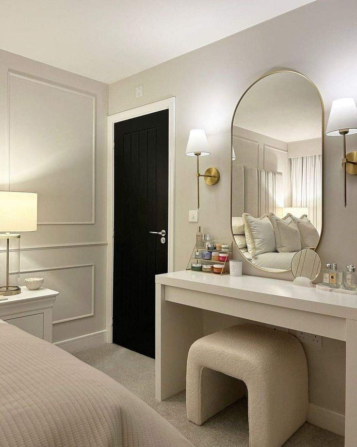 a bedroom with a large mirror and dressing table