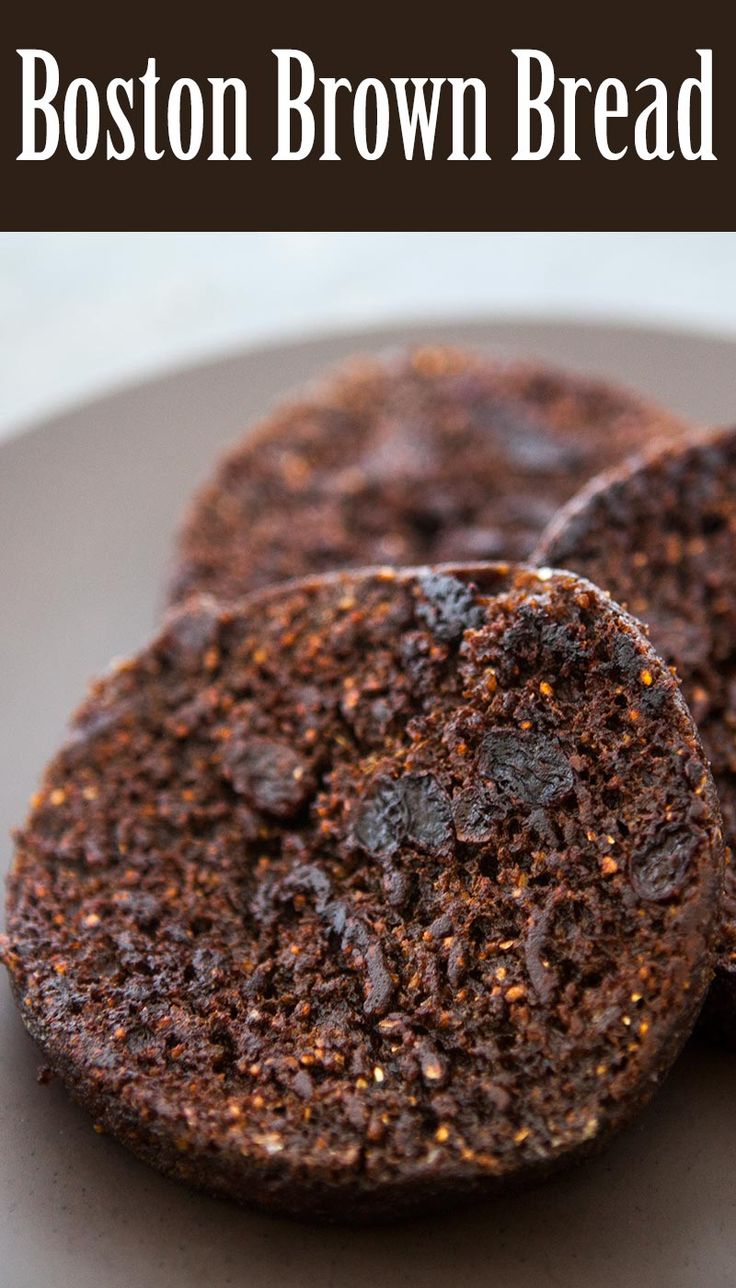 two chocolate brown breads on a plate with the words boston brown bread above them