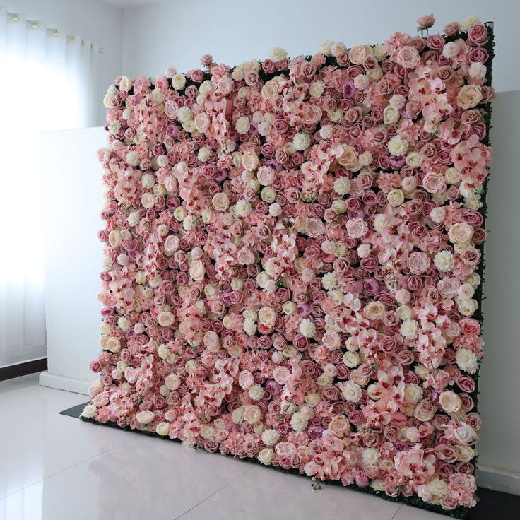 a wall made out of pink and white flowers