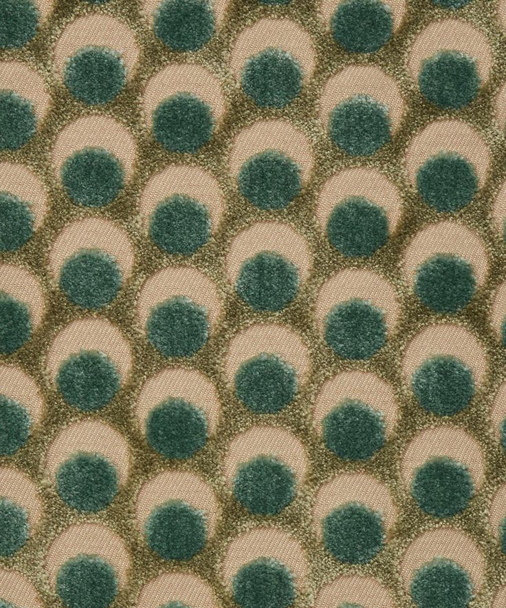 a green and beige rug with circles on it