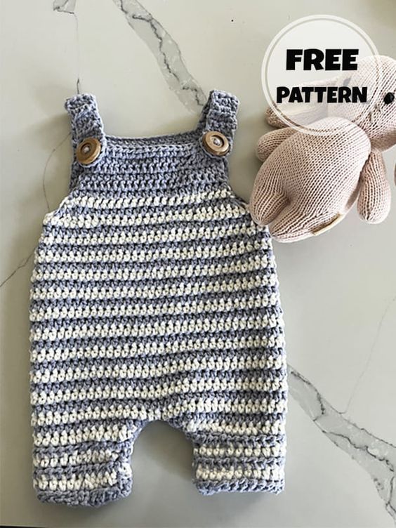 a crocheted baby romper and mitten on a marble surface with free pattern