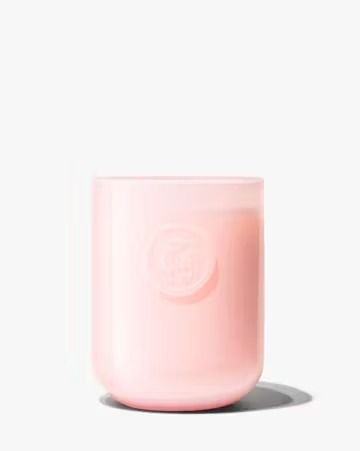 a pink glass jar sitting on top of a white surface