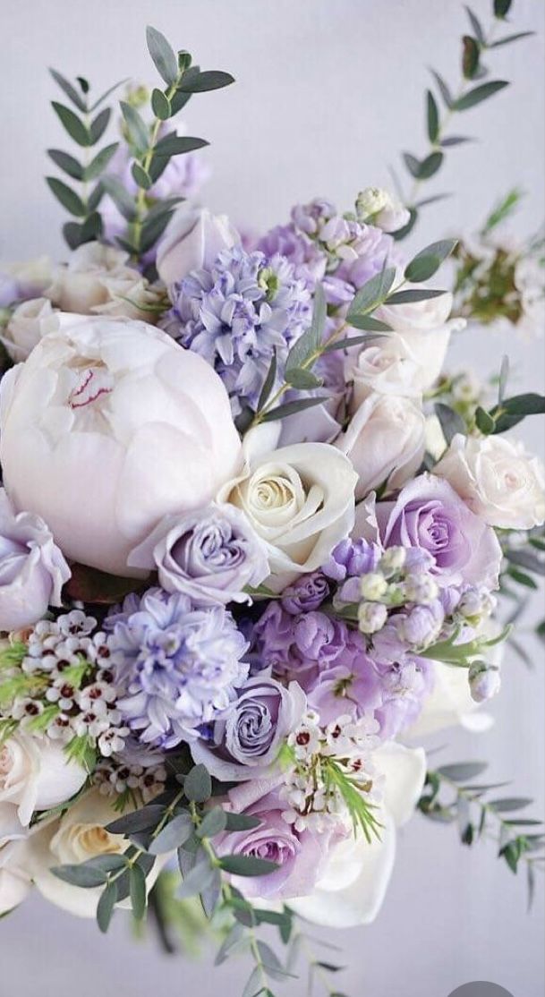 a bridal bouquet with purple and white flowers