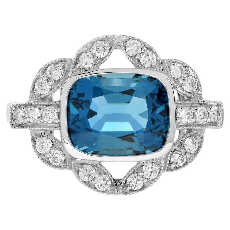 Make a statement with this Art Deco inspired London Blue Topaz Engagement Ring. The emerald cut topaz in the center is accented by shimmering diamonds. This ring, crafted in solid white gold, is perfect for those who appreciate antique and artistic jewelry. Ring Information Style: Vintage Metal: 14K White Gold Total weight: 3.70 g. (approx. total weight) US 3 – 8 available Center Gemstones Type: London Blue Topaz Shape: Emerald Cut Size: 10 x 8 mm. Number: 1 Weight: 3.90 Carat (approx. total weight) Accent Gemstones Type: Diamond Shape: Round Average Color: H Average Clarity: SI Size: 1.5 mm. Number: 22 Weight: 0.30 Carat (approx. total weight) This ring will be made to your order in 1-2 weeks, contact us to find out more. An attractive ring box is included. Most of our rings can be sized Luxury Art Deco Topaz Ring With Diamond, Luxury Blue Topaz Art Deco Ring, Art Deco Sapphire Ring With Vvs Clarity, Luxury Art Deco Sapphire Ring With Brilliant Cut, Luxury Art Deco Sapphire Ring In Diamond White, Blue Cabochon Art Deco Rings, Blue Topaz Engagement Ring, Topaz Engagement Ring, Inspiration Art