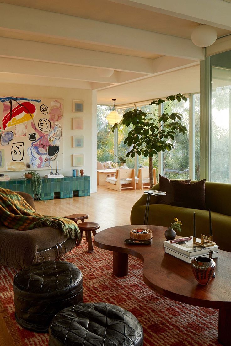 a living room filled with furniture and lots of windows