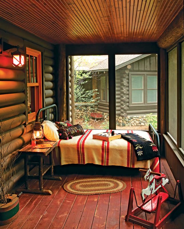 a bedroom with wood flooring and wooden walls