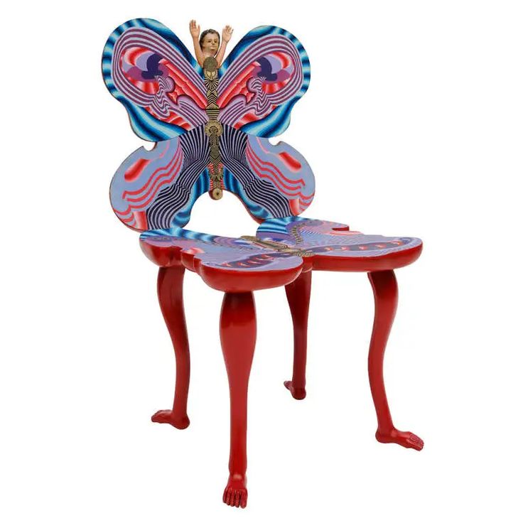 a butterfly shaped table with two stools on it's legs and a woman sitting on the top