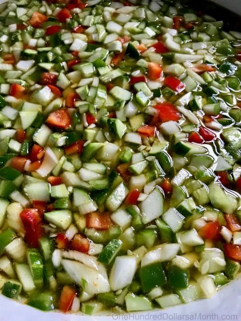 a pot filled with vegetables sitting on top of a stove