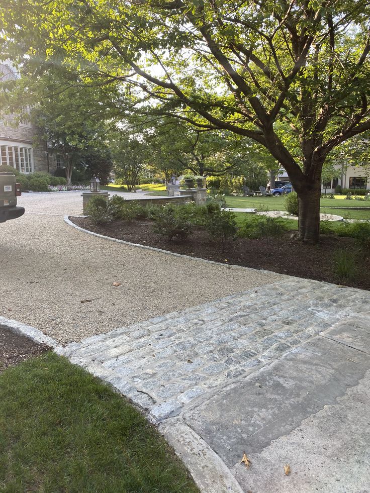 a stone walkway in the middle of a park