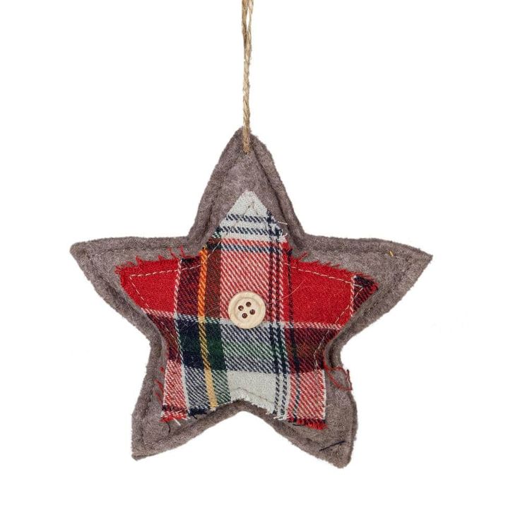 a red plaid star ornament hanging from a string with a button on it