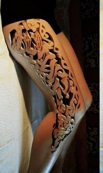 someone is holding their arm with intricate carvings on it's sides and the arms are covered in white paper