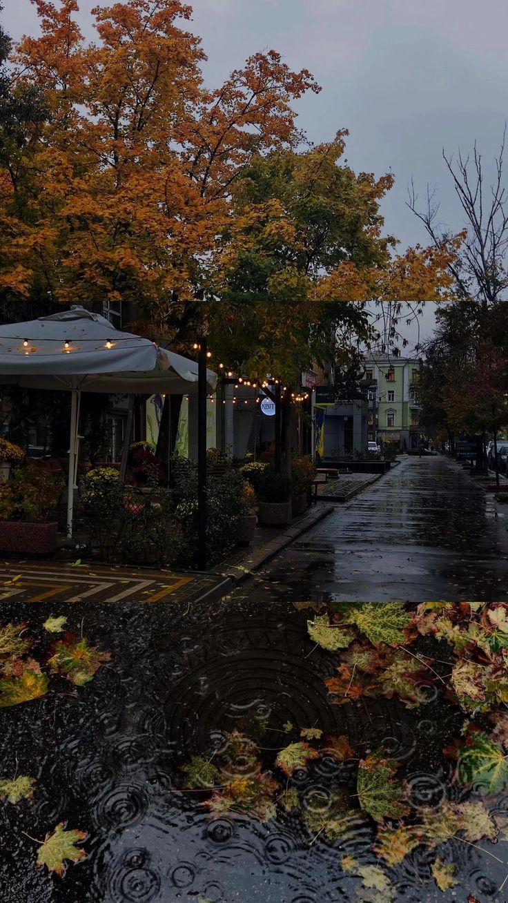 an empty street with umbrellas and tables in the rain on it's side