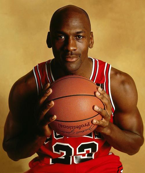 michael jordan is holding a basketball in front of the chicago bulls'logo on a card