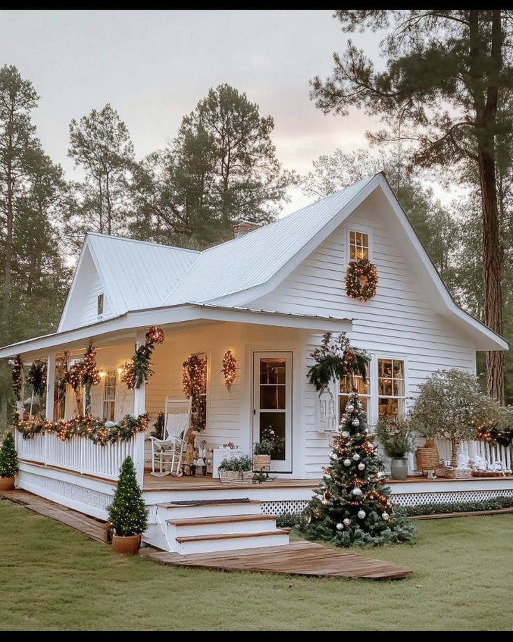 a white house with christmas decorations on the porch