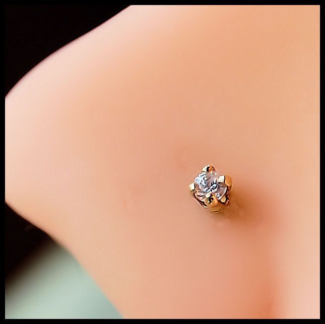 an image of a woman's breast with a diamond ring on it